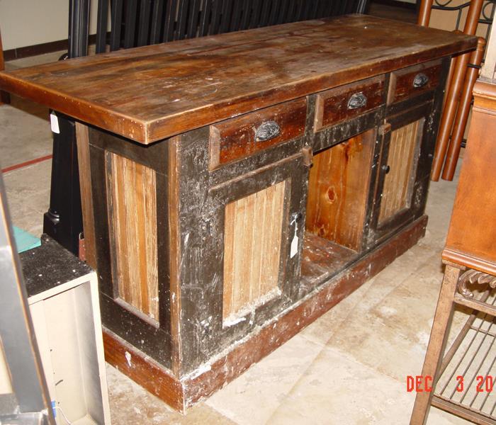 Image shows a home made wooden bar with water stains.